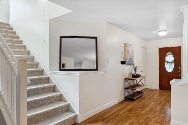 entrance foyer with wood-type flooring and decorative columns