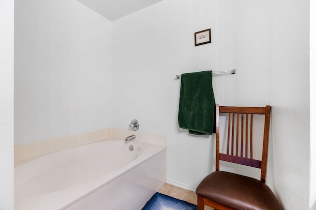 bathroom with tile patterned floors and a tub to relax in