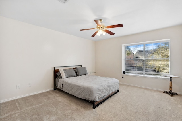 bedroom with light carpet and ceiling fan