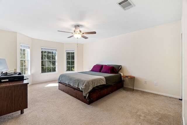 bedroom with ceiling fan and light colored carpet