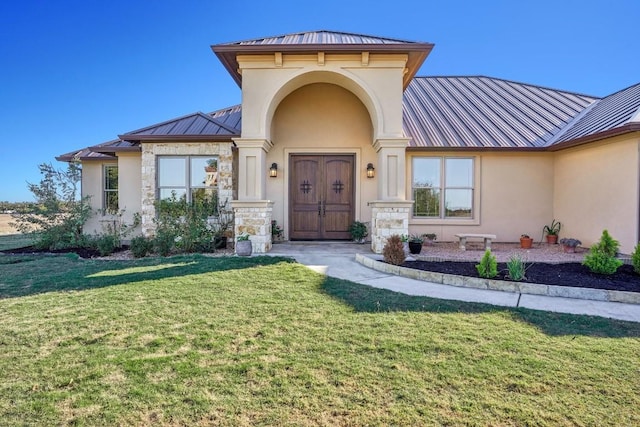 entrance to property with a lawn