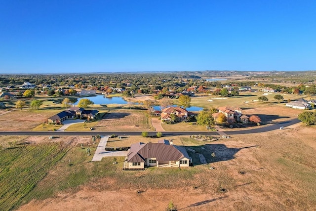 drone / aerial view featuring a water view and a residential view