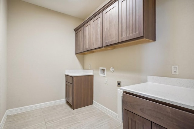 laundry room with hookup for an electric dryer, baseboards, washer hookup, and cabinet space
