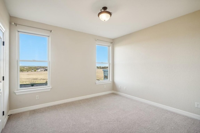 unfurnished room featuring baseboards and carpet flooring