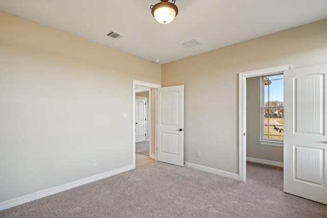 unfurnished bedroom featuring light colored carpet