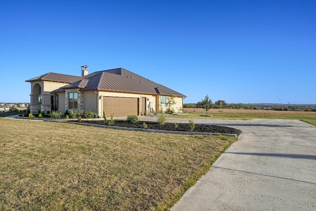 view of front of home with a front lawn and a garage