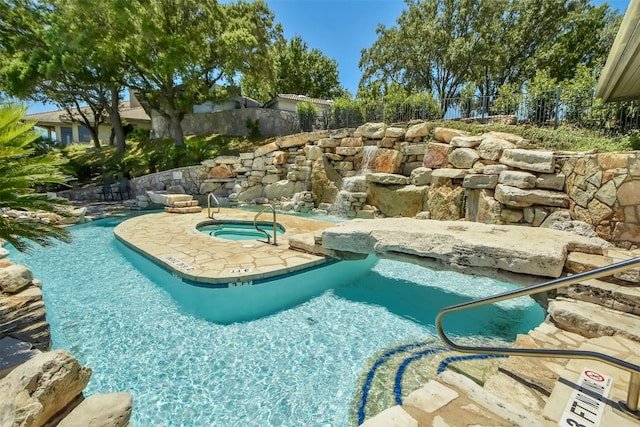 view of pool featuring a hot tub