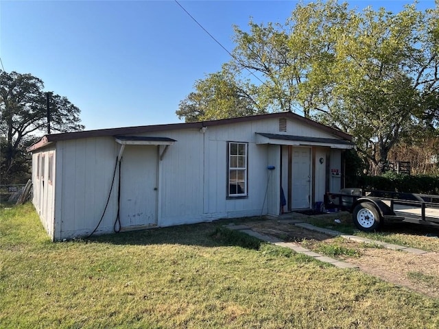 view of outbuilding with a yard