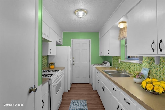 kitchen featuring white cabinets, white range with gas cooktop, and sink