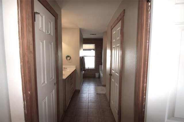 hallway with dark tile patterned floors