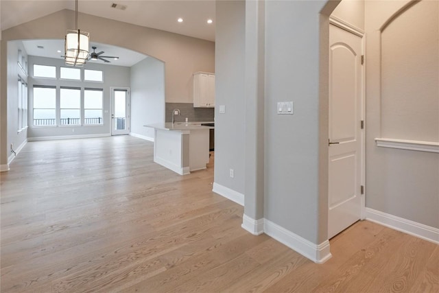 interior space featuring ceiling fan, light hardwood / wood-style flooring, and sink