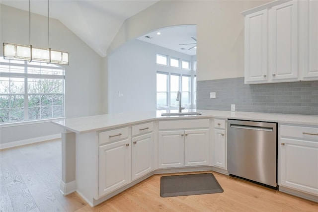 kitchen with dishwasher, white cabinets, plenty of natural light, and sink