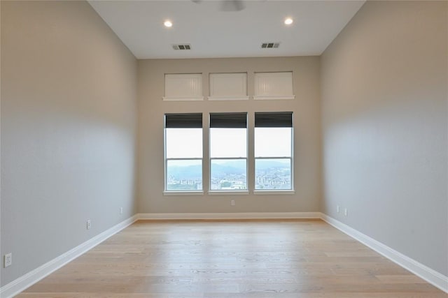 unfurnished room with light hardwood / wood-style flooring