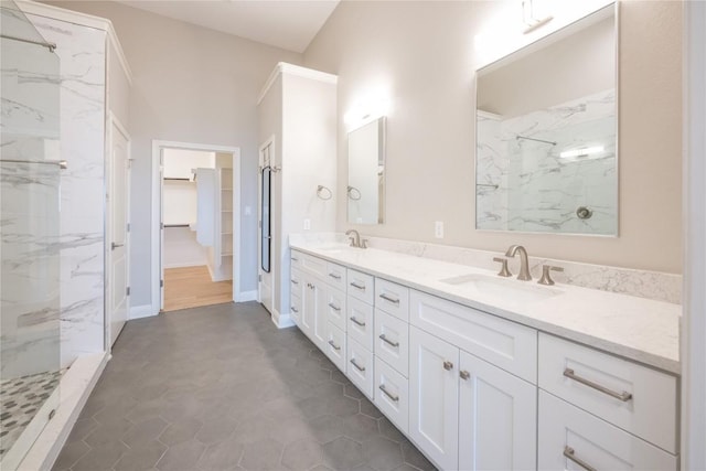 bathroom with vanity and tiled shower