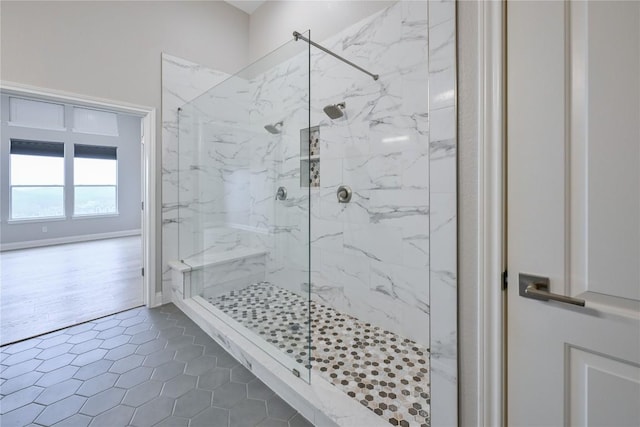 bathroom with tile patterned floors and tiled shower