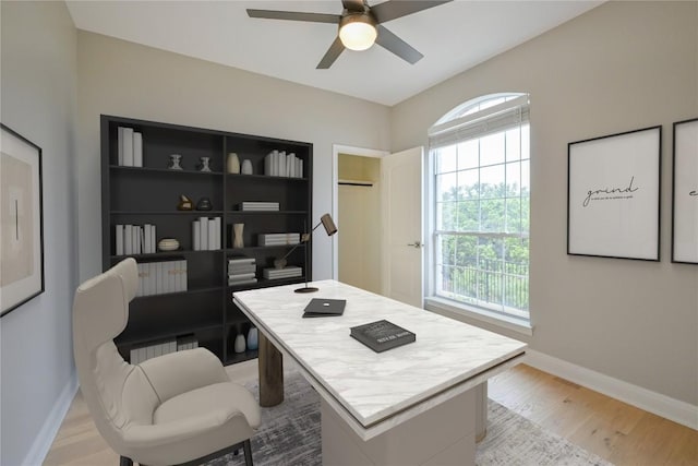 office with ceiling fan and light hardwood / wood-style floors