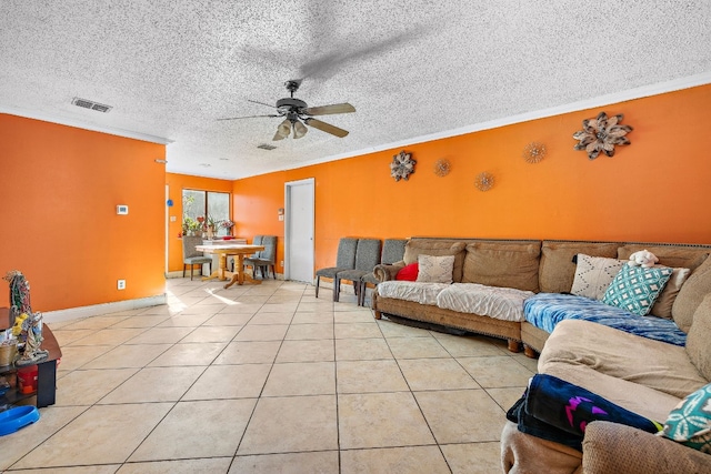 living room with crown molding, light tile patterned floors, and a textured ceiling