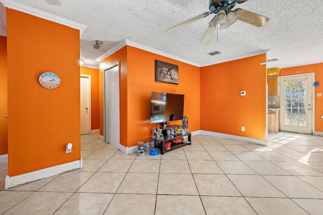 unfurnished living room with ceiling fan, ornamental molding, a textured ceiling, and light tile patterned floors