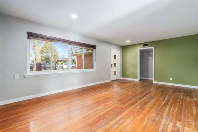 spare room featuring wood-type flooring