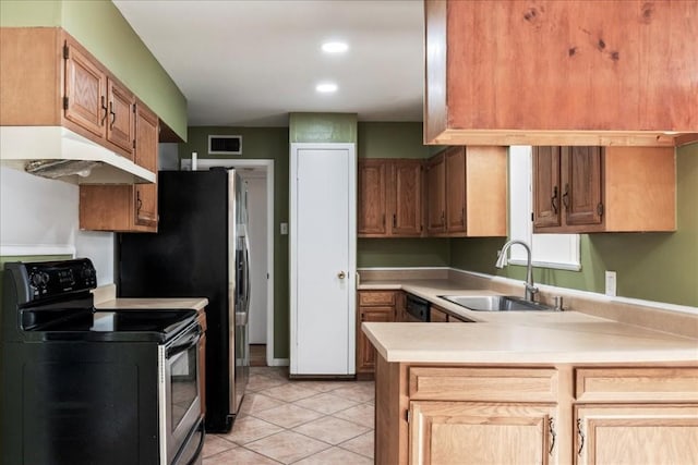 kitchen with kitchen peninsula, black electric range, light tile patterned floors, and sink