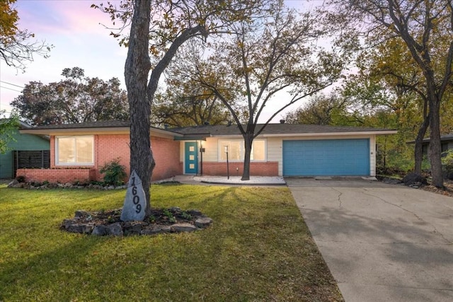 ranch-style home with a yard and a garage