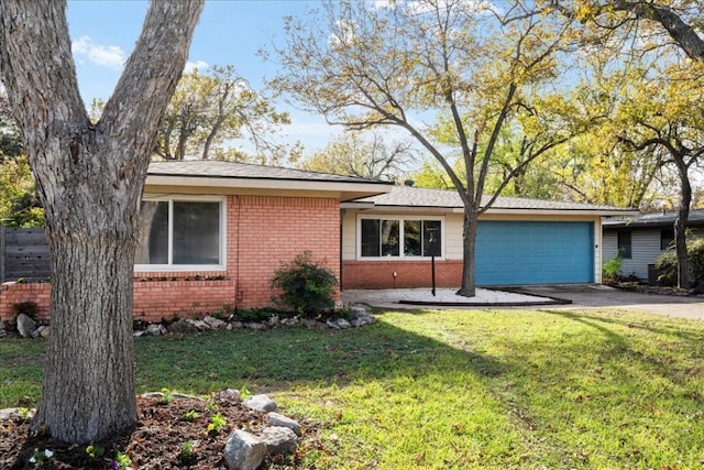 view of front of house with a front yard and a garage