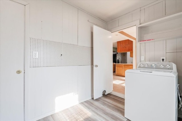 laundry room featuring washer / clothes dryer and light hardwood / wood-style floors