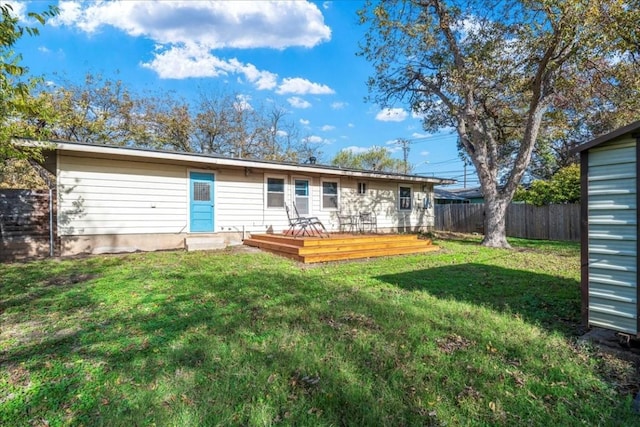 back of house with a lawn and a wooden deck