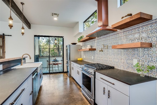 kitchen with wall chimney exhaust hood, hanging light fixtures, stainless steel appliances, backsplash, and white cabinets