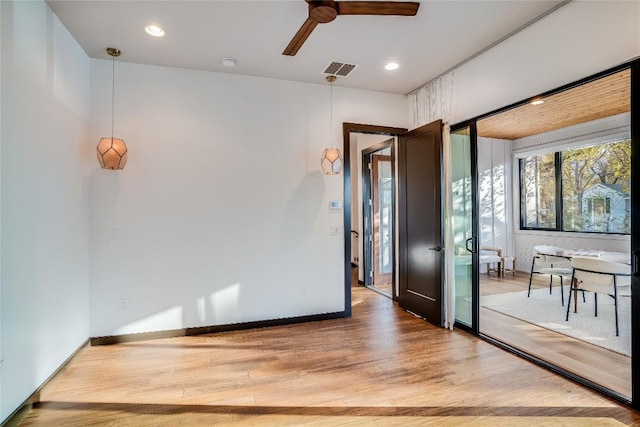 unfurnished room with ceiling fan and wood-type flooring