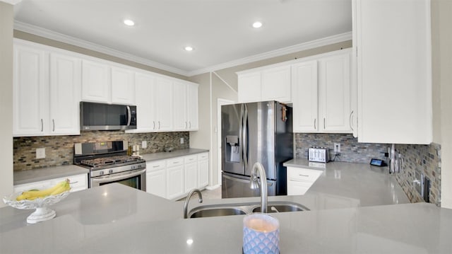 kitchen featuring white cabinets, decorative backsplash, sink, and appliances with stainless steel finishes