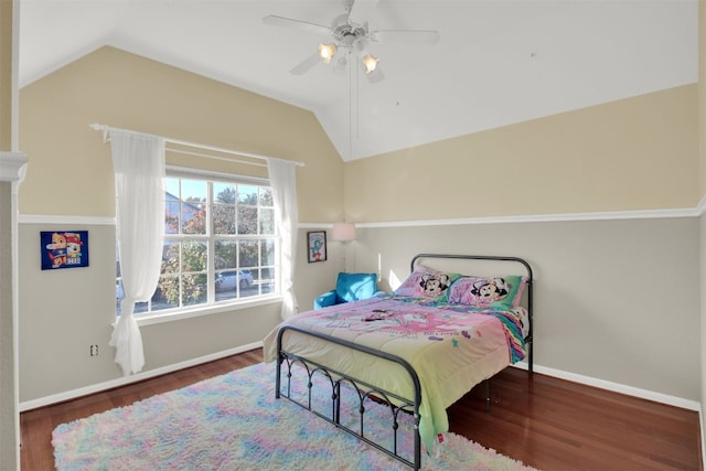 bedroom with ceiling fan, dark hardwood / wood-style floors, and lofted ceiling