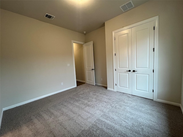 unfurnished bedroom with a closet and carpet