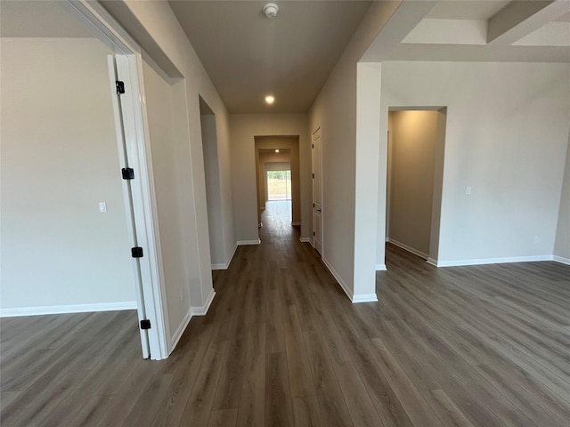 corridor with dark hardwood / wood-style flooring