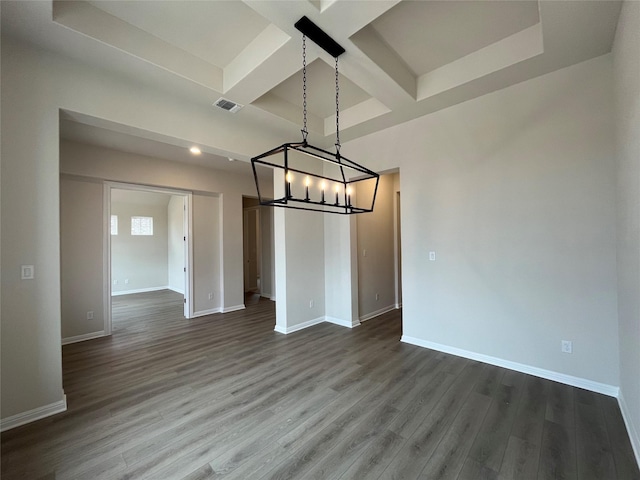 unfurnished dining area featuring beamed ceiling, wood-type flooring, and coffered ceiling