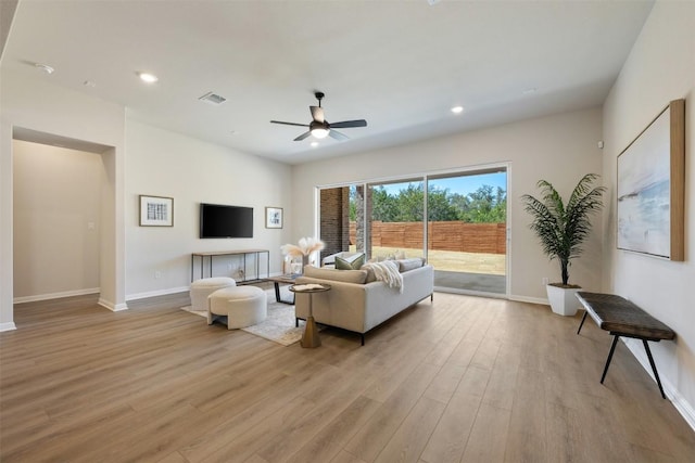 living room featuring recessed lighting, visible vents, light wood-style flooring, a ceiling fan, and baseboards