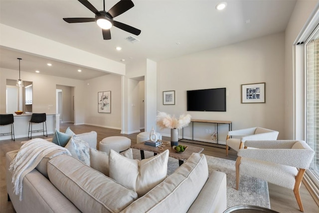 living area with baseboards, visible vents, ceiling fan, wood finished floors, and recessed lighting