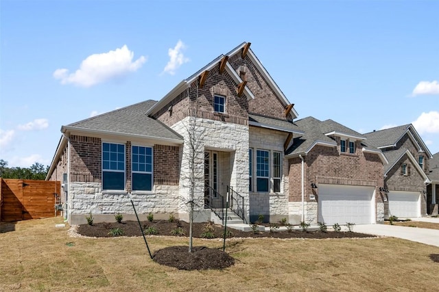 view of front of home featuring driveway, stone siding, roof with shingles, fence, and brick siding