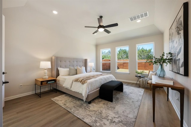 bedroom featuring baseboards, visible vents, wood finished floors, and recessed lighting