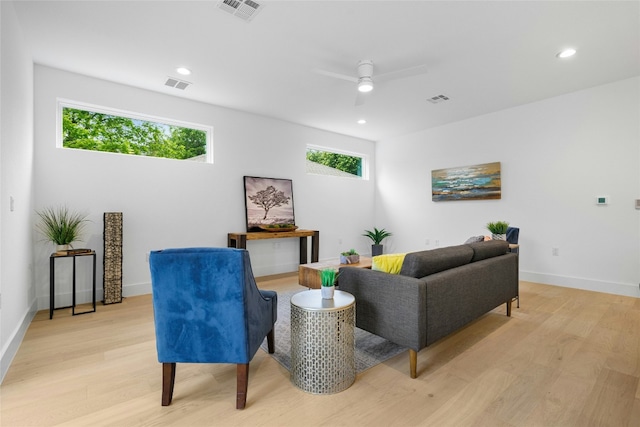 living room featuring ceiling fan and light hardwood / wood-style flooring