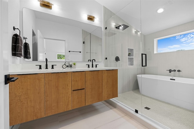 bathroom with tile patterned floors, vanity, separate shower and tub, and tile walls