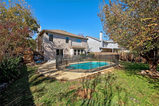 view of swimming pool featuring a lawn and a patio