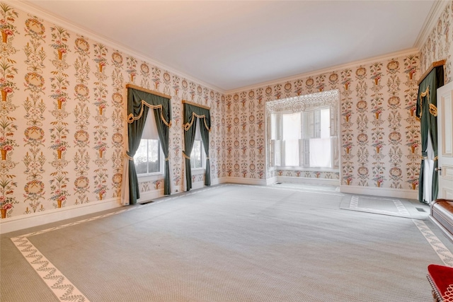 carpeted empty room with a wealth of natural light and ornamental molding