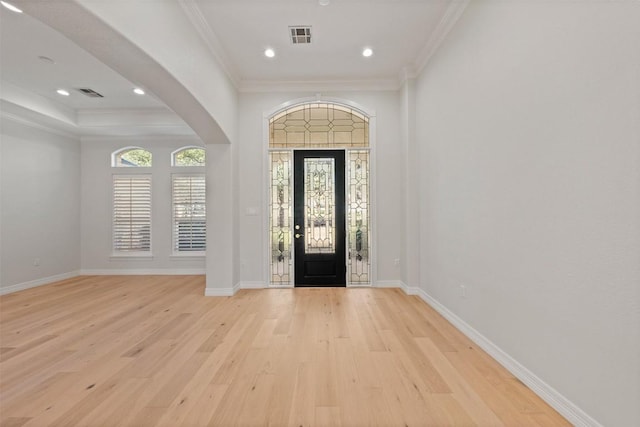 entryway with crown molding and light wood-type flooring