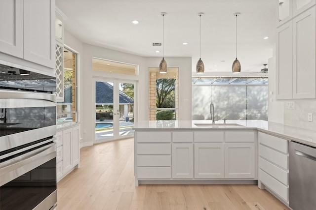 kitchen featuring white cabinets, sink, and appliances with stainless steel finishes