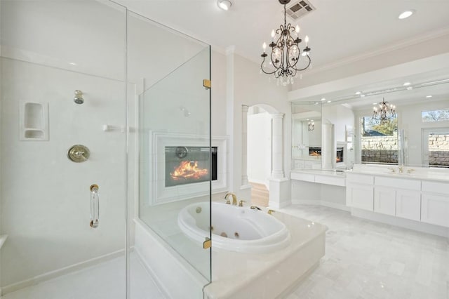 bathroom featuring a bathtub, vanity, a notable chandelier, and ornamental molding