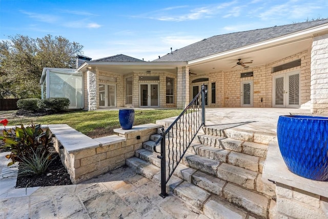 back of house with french doors, ceiling fan, and a lawn