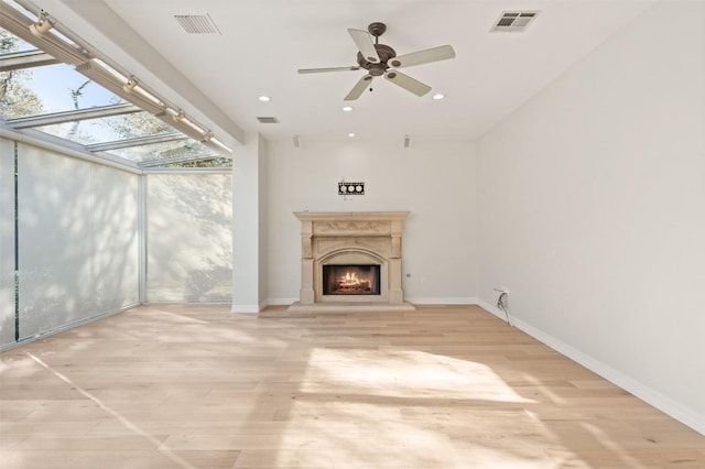 unfurnished living room featuring ceiling fan and light hardwood / wood-style floors