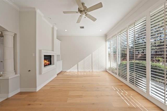 unfurnished living room featuring light hardwood / wood-style flooring, ceiling fan, and ornamental molding