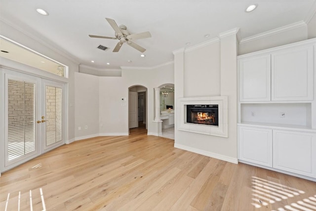 unfurnished living room with ceiling fan, light hardwood / wood-style floors, and crown molding